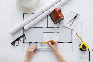 business, architecture, building, construction and people concept - close up of architect hands with ruler and pencil measuring living house blueprint